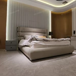 Warm Taupe Upholstered Bed with Tiered Headboard, Lacing Detail & Stainless Steel Accents